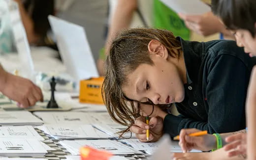 a young girl writing on a paper
