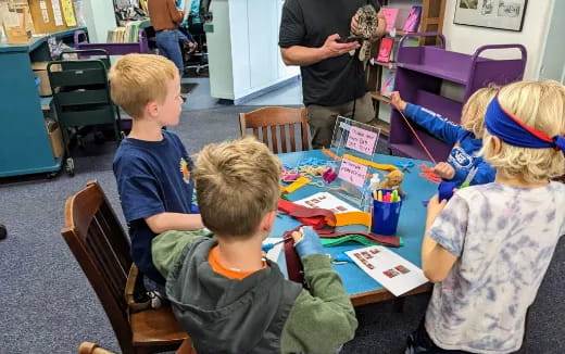 a group of children sitting around a table