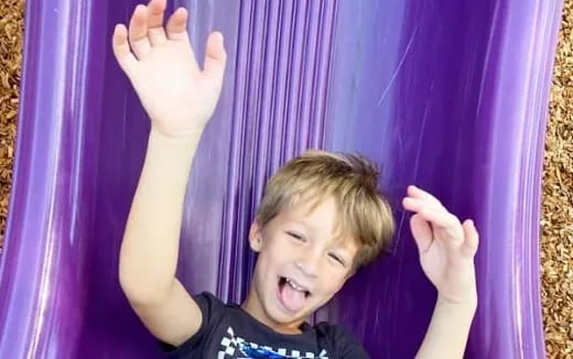 a boy with his hands up