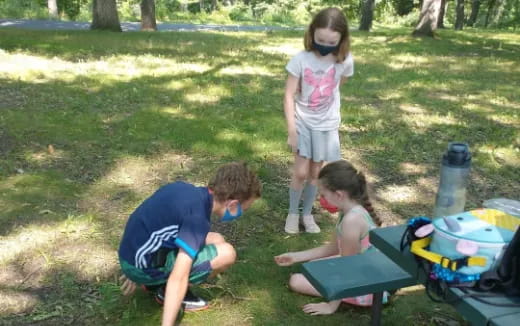 a group of kids playing in the grass