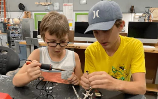 a couple of boys working on a project