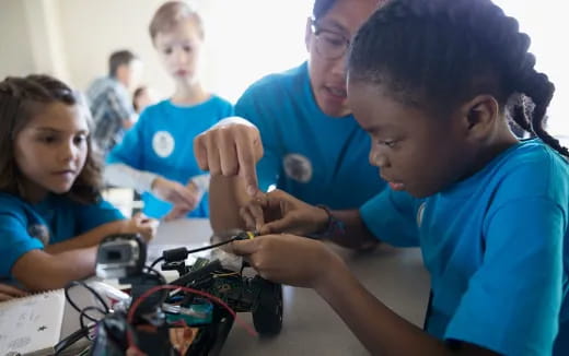 a group of children working on a computer