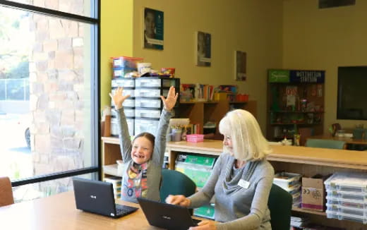 a person and a boy with their hands up in the air