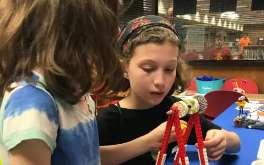 a person and a girl playing with a toy