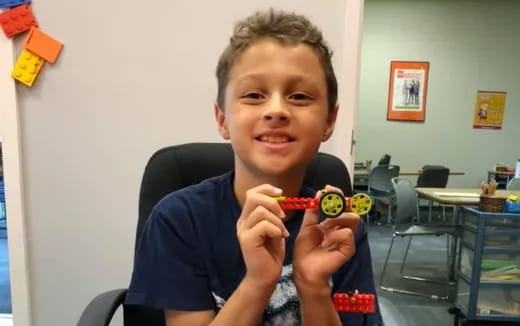 a boy holding a toy