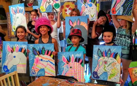 a group of children holding up posters