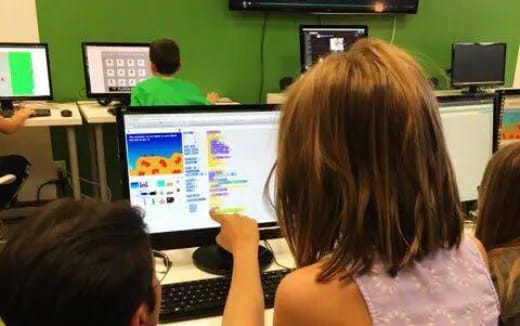 a group of people sitting at computers