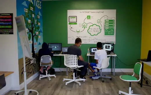 a group of people sitting at computers