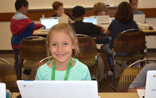 a girl smiling in a classroom
