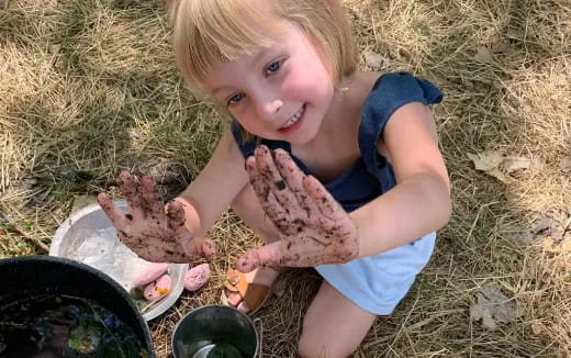 a young girl holding a fish
