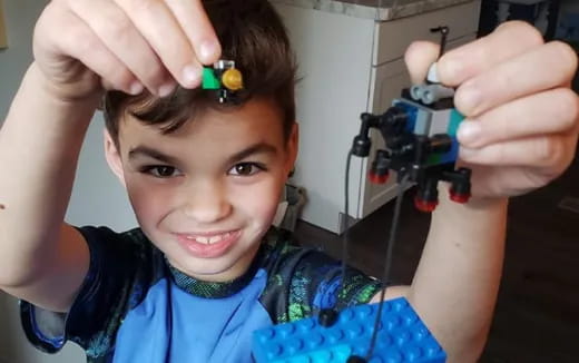 a boy with a green object on his head