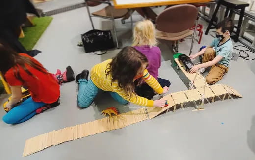 a group of children playing with a toy