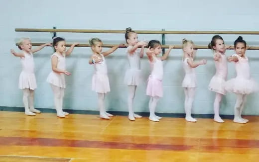 a group of children in white dresses