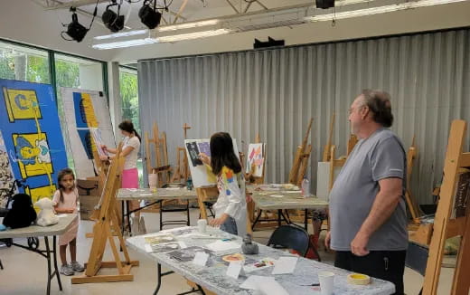 a person painting in a classroom