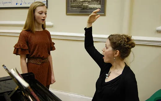 a woman standing next to another woman