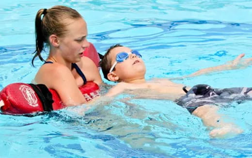 a couple of people in a pool