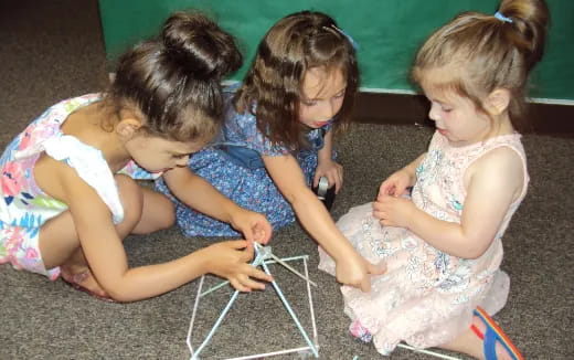 a group of girls sitting on the floor