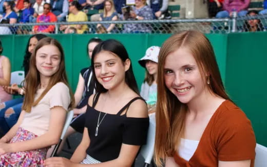 a group of women sitting together smiling