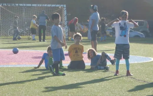 a group of kids playing football