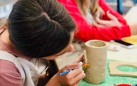 a child painting on a table