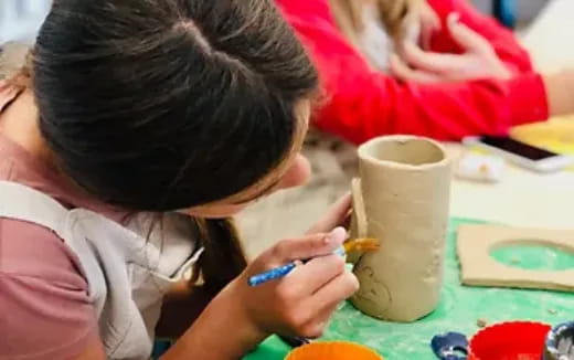 a child painting on a table
