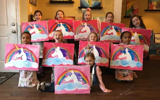 a group of children holding colorful paper bags