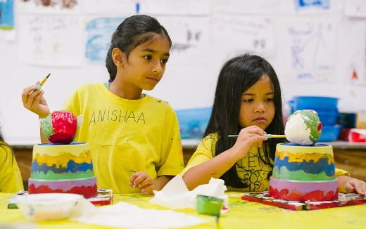 a couple of young girls eating ice cream