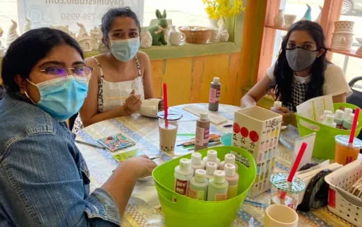 a group of women wearing masks
