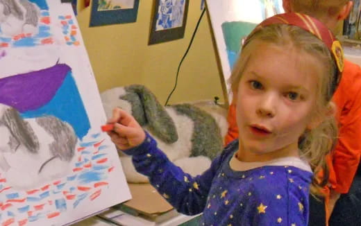 a child holding a marker pen