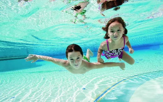 a man and woman in a pool