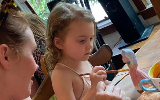 a little girl holding a spoon
