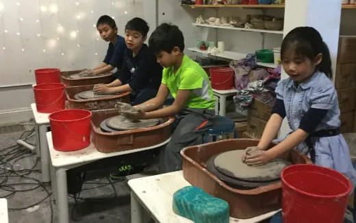 a group of kids working in a workshop
