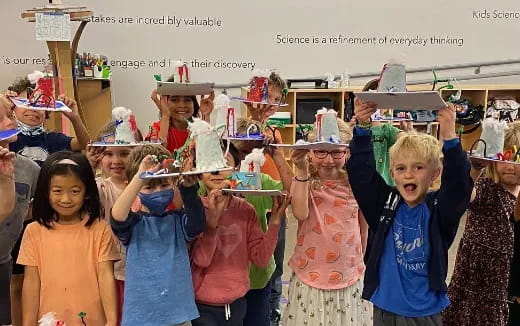 a group of children wearing party hats
