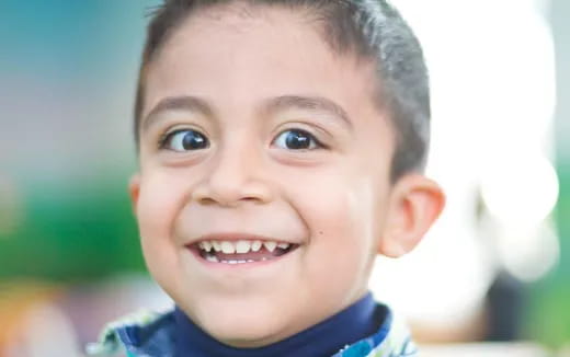 a close-up of a boy smiling
