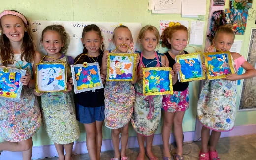 a group of children holding up books