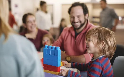 a person and a child playing with a toy
