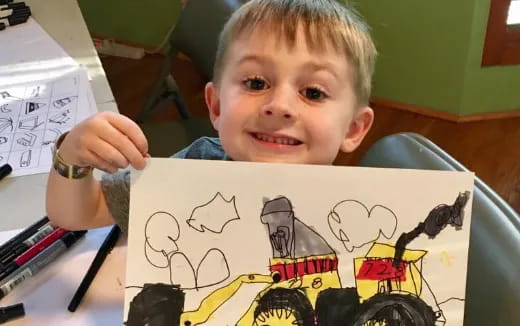 a child drawing on a paper