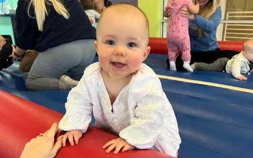 a baby sitting on the floor