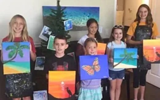 a group of children holding up books