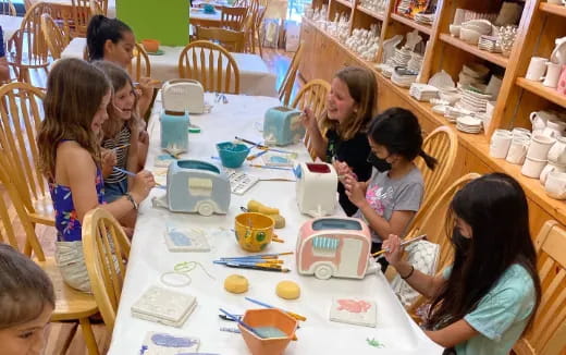 a group of children sitting around a table