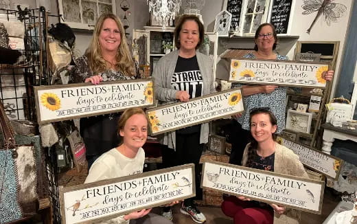 a group of women holding signs