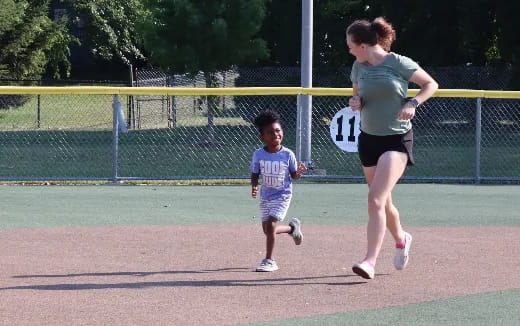 a person and a child running on a track