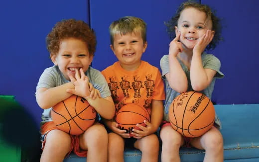 a group of kids holding basketballs
