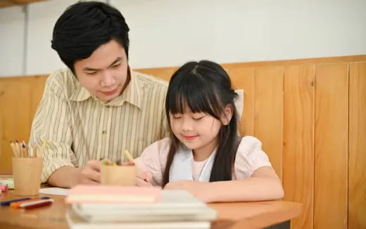 a woman and a girl studying