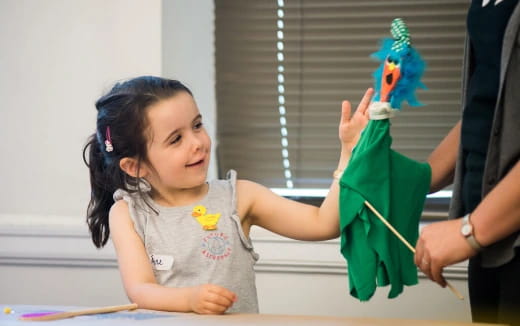 a girl holding a green object