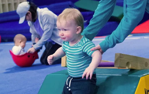 a baby playing on a toy train