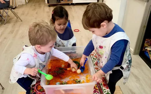 a group of children playing with a toy