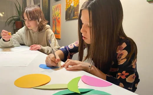 a woman and a child painting