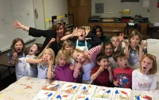 a group of children raising their hands