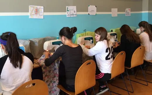 a group of people sitting in a classroom